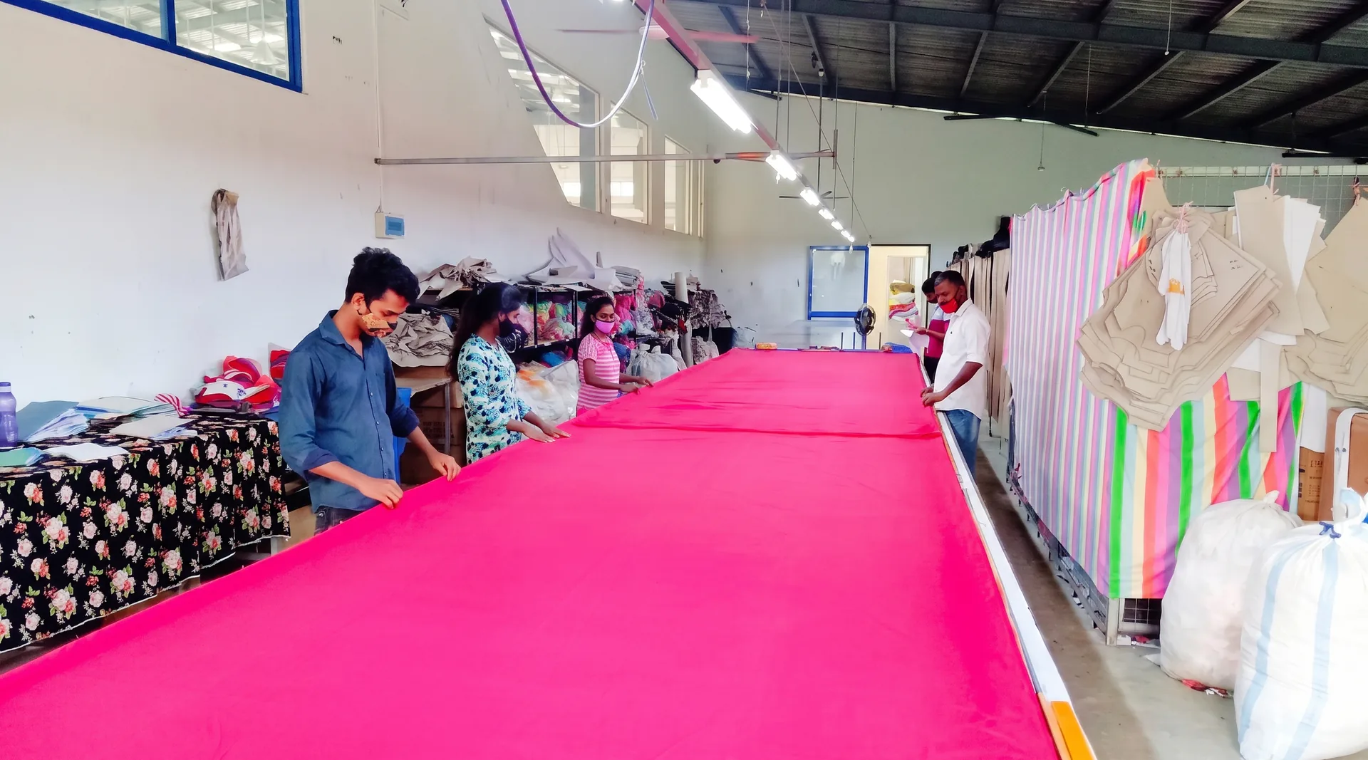 Cutting department with fabric spread across cutting tables