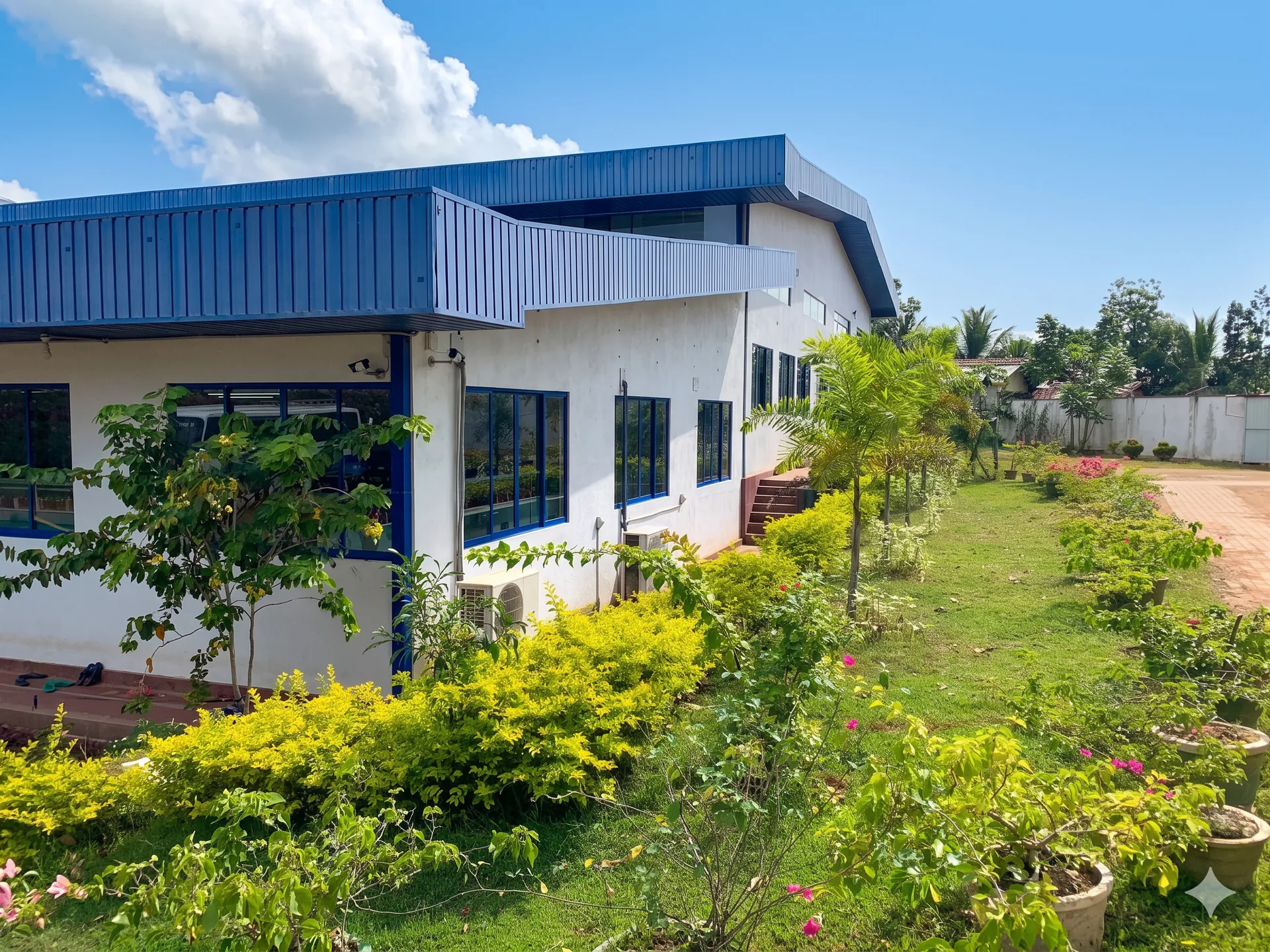 Side exterior and landscaped grounds of the Dewmini Fashion factory